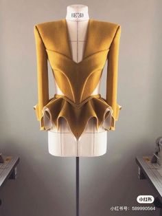 a mannequin with yellow and white clothing on display