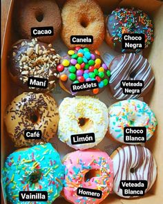 a box filled with lots of different flavored donuts