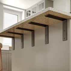 a kitchen with an island made out of concrete blocks and metal brackets on the wall