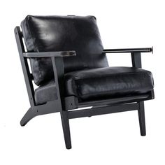 a black leather chair sitting on top of a white floor next to a wooden frame