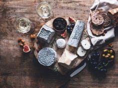 cheese, bread and fruit on a wooden table