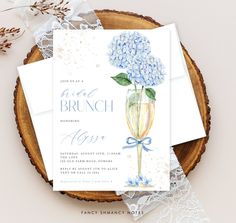 an elegant brunch party with hydrangeas in a champagne glass and lace