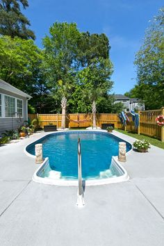 an empty swimming pool in the middle of a backyard