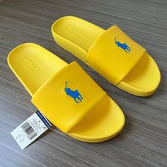 Polo Ralph Lauren Cayson Big Pony Slide Us Sizes Color: Yellow Fin/Blue This Classic Pool Slide Gets A Signature Polo Finish With Ralph Lauren's Iconic Big Pony Embroidered At The Top. A Padded Eva Construction Provides Extra Support And Comfort. Open Toe. Slip-On Styling. Padded Footbed. Eva Midsole. Signature Pony Embroidered At The Top. Knit Lining At The Vamp. Treaded Rubber Outsole. Upper: 100% Polyurethane. Lining: 80% Nylon, 20% Elastane. Imported. Thanks For Looking And Good Luck! Casual Yellow Sport Sandals With Removable Insole, Yellow Non-slip Slide Flip Flops, Comfortable Yellow Non-slip Sandals, Comfortable Yellow Slip-on Flip Flops, Yellow Rubber Sole Slides For Summer, Yellow Slides With Rubber Sole For Summer, Yellow Summer Slides With Rubber Sole, Yellow Non-slip Synthetic Flip Flops, Yellow Sporty Sandals For Summer