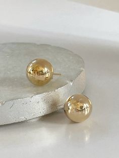 Ball Post Earrings  D E T A I L S - 18K Gold Filled Earrings - Size Diameter 14mm - Sold as a pair - Lightweight with a hollow inside - Push Back Closure P A C K A G I N G Dylan Rae Jewelry is elegantly presented in our premium microfiber jewelry case, ensuring both protection and a polished presentation. If you require separate packaging for multiple items, kindly let us know. C A R E Care for Your Gold Filled Jewelry: Wear It, Love It, Care for It! Our gold-filled pieces are crafted to be your lifelong companions. Feel free to wear them every day, even while showering, but remember to avoid exposing them to saltwater and chlorine. These elements can diminish their luster over time and may even cause oxidation if they come in contact with your jewelry. Additionally, it's best to remove yo Gold Earrings With Round Beads For Pierced Ears, Gold Hypoallergenic Round Bead Earrings, Gold Hypoallergenic Earrings With Round Beads, Gold Hypoallergenic Earrings, Gold Round Beads Earrings For Everyday, Everyday Gold Round Bead Earrings, Everyday Gold Round Beaded Earrings, Classic Gold Earrings With Round Beads, Ball Earrings Gold