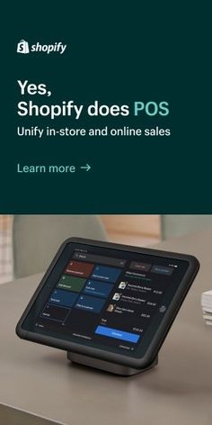 an electronic device sitting on top of a table with the words shopify does pos