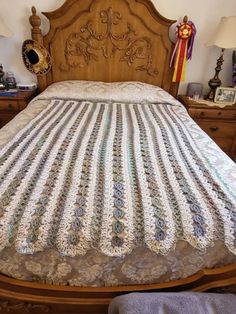 a bed with an ornate wooden headboard and foot board