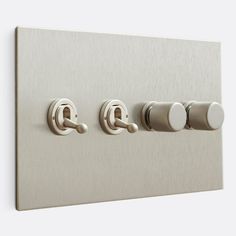 an electrical outlet with three knobs and two switches on each side, in stainless steel