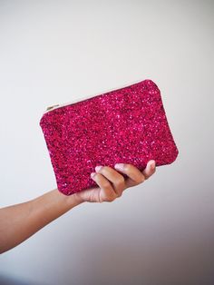 "Fuchsia Glitter Makeup Bag. This sparkly pink makeup bag is made out of a glitter covered cotton and would be the perfect accessory for a wedding, event and Christmas parties.  Each bag comes with a beige YKK zip with gold teeth and measures about 7\" x 5\". These would make stunning gifts and add some sparkle to your wardrobe. They're small enough to fit inside a bigger handbag and keep all your toiletries and makeup bits safe whilst big enough to use as a small clutch for a night out.  The in Sparkly Pink Makeup, Rosa Make-up, Pink Glitter Makeup, Glitter Clutch Bag, Sparkly Makeup, Pink Makeup Bag, Glitter Clutch, Gold Teeth, Small Makeup