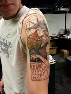 a man with a tattoo on his arm that says wizard's brew and an image of a witch