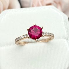 This beautiful ring is made from genuine 925 sterling silver with rose gold plating. Ring details- -The Main stone is a round cut 6.5mm lab created Pink Ruby -Side stones are 1mm and 2mm simulated diamonds -Ring is casted in solid 925 sterling silver with rose gold plating (rhodium and yellow gold plated also available, please check the drop down menu for more options) -The Total face height of the ring measures 7mms and the band width measures 2mms -Each ring is handmade, so please allow suffic Pink Gold Round Ruby Ring With Prong Setting, Ruby Ring With Prong Setting And Moissanite, Pink Gold Ruby Ring With Prong Setting, Round Cut Lab-created Ruby Ring With Prong Setting, Pink Gold Diamond Ring With Round Cut Prong Setting, Rose Gold Ruby Ring With Center Stone For Promise, Promise Ruby Ring With Center Stone In Rose Gold, Pink Gold Ring With Brilliant Round Cut, Classic Rose Gold Ruby Ring With Round Cut