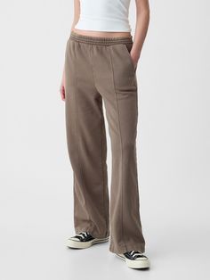 Soft fleece knit wide-leg sweatpants.  Elasticized waist.  Front slant pockets.  Seam at front.  Mid rise.  Straight silhouette with a relaxed fit.  Wide leg.  Models wearing Gap Gap Full Length Relaxed Fit Pants, Gap Relaxed Fit Full Length Pants, Gap Relaxed Fit Full-length Pants, Gap Relaxed Fit Cargo Pants, Gap Relaxed Fit Wide-leg Pants, Casual Everyday Pants By Gap, Comfortable Wide Leg Sweatpants For Elevated Casual Wear, Gap Cotton Bottoms With Straight Hem, Gap Wide Leg Pants With Elastic Waistband