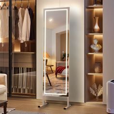 a large mirror in the middle of a room with clothes hanging on shelves and an air humider nearby