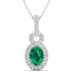 This exquisite oval-shaped emerald and diamond pendant exudes elegance and sophistication. Crafted with precision and attention to detail, this stunning piece features a vibrant emerald center stone surrounded by sparkling diamonds, creating a luxurious and timeless look. Metal: 14K Gold Setting Type: Prong Rhodium Finish: Yes, on White Gold Gemstone Details: Gemstone: Emerald Shape: Oval Average Dimensions: 8.00 x 6.00 MM Quantity: 01 Average Cut: Very Good Average Color: Medium to Dark Green A Oval Emerald Necklace With Diamond Accents, Oval Green Emerald Necklace With Diamond Accents, Fine Jewelry Diamond Emerald Necklace With Oval Pendant, Oval Emerald Diamond Necklace In White Gold, Fine Jewelry Emerald Necklace With Oval Diamond Pendant, Oval Emerald And Diamond Necklace, Emerald Necklace With Diamond Oval Pendant, Fine Jewelry, Formal Emerald Oval Pendant Necklace, Green Emerald Necklace With Diamond Halo Setting