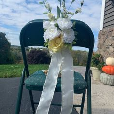 a bouquet of flowers sitting on top of a green chair