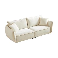 a white couch with two pillows on it's back and one arm facing the camera