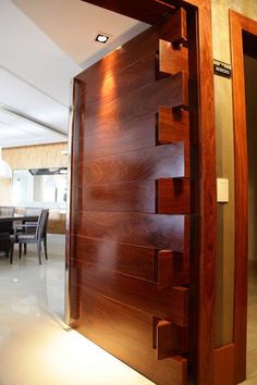 an open wooden door leading into a dining room