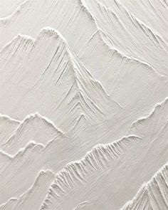 an abstract white painting with mountains in the background