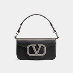 Valentino "Loco" shoulder bag in lambskin leather Features embellished VLOGO accent  Detachable flat top handle  Detachable, sliding chain shoulder strap Flap top with magnetic closure  Interior, one slip pocket Approx. 4.3"H x 7.9"W x 2"D Made in Italy Designer Handheld Flap Bag, Luxury Shoulder Bag With Logo Hardware For Shopping, Luxury Handheld Bags With Silver-tone Hardware, Luxury Shoulder Bag With Silver-tone Hardware Handheld, Luxury Bag With Silver-tone Hardware And Top Handle, Luxury Bags With Silver-tone Hardware And Top Handle, Designer Clutch Shoulder Bag With Silver-tone Hardware, Luxury Handheld Shoulder Bag With Silver-tone Hardware, Luxury Satchel Shoulder Bag With Silver-tone Hardware