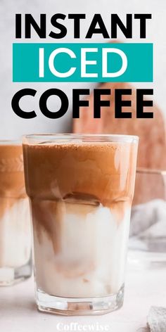 two glasses filled with iced coffee sitting on top of a white table next to each other