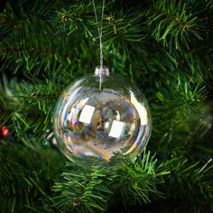 a glass ornament hanging from a christmas tree