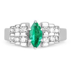 an emerald and diamond ring on a white background