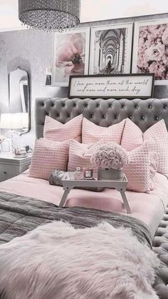 a pink and gray bedroom with pictures on the wall above the headboard, rugs and pillows