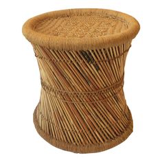 a round wicker stool with an intricate design on the top and bottom, made out of