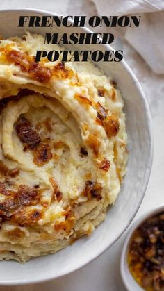 a white bowl filled with mashed potatoes next to a small bowl of other food