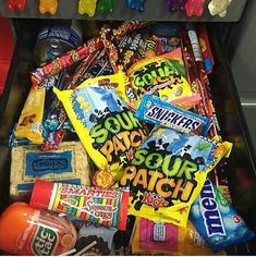 an open gummy machine filled with lots of different flavored candy and candies