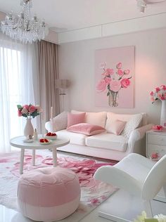 a living room filled with white furniture and pink flowers