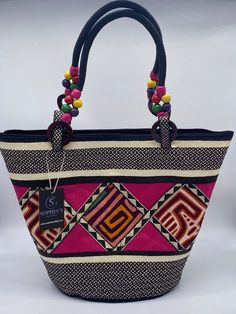 These beautiful handbags are made from Cana Flecha which is an indigenous palm fiber found in the northern territory of Colombia. They are beautifully hand crafted by the people from the Zenu tribes in Colombia. These handbags are colorful with vibrant colors, which is a pure reflection on the region and the warmness of these master artisans that work in this industry every day. Traditional Rectangular Bag With Handles, Traditional Rectangular Bags With Handles, Traditional Handmade Top Handle Bag, Traditional Shoulder Bag With Handles, Daily Use Fair Trade Jute Bag, Fair Trade Tote Bag For Vacation, Traditional Top Handle Woven Bag, Traditional Woven Top Handle Bag, Rectangular Travel Bag With Weaving Work