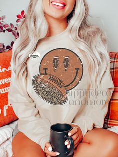 a woman sitting on a couch holding a coffee mug