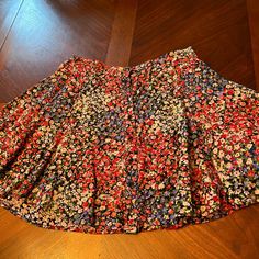 This Skirt Is New, But The Price Tag Has Been Removed. The Additional Tiny Black Button Is Still Attached. This Floral Skirt Is Not A Skirt, But Has A Black Underlay To Protect From Seeing Through. There Are Some Delicate Tiny Black Buttons All The Way Up The Skirt In The Front, And It Is Pleated. Comes From A Smoke Free Home Top Of The Waistband To The Bottom Of The Skirt Is 15 Inches.Size Is S-P. But Not Sure That Means Petite. My Daughter Is A Small But She’s Not A Petite Spring Multicolor Bottoms With Buttons, Casual Tiered Skirt With Buttons, Casual Tiered Skirt With Button Closure, Multicolor Buttoned Skirt For Spring, Fitted Button-up Mini Skirt With Lining, Button-up Lined Skirt For Day Out, Button-up Relaxed Skirt For Spring, Spring Button-up Lined Skirt, Fitted Button-up Lined Mini Skirt