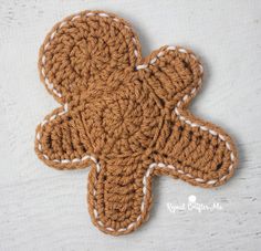 a crocheted ginger cookie is shown on a white surface