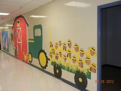 this is a photo of a school hallway decorated with farm animals and tractor themed decorations