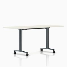 a white table with black wheels on the bottom and one end in front of it