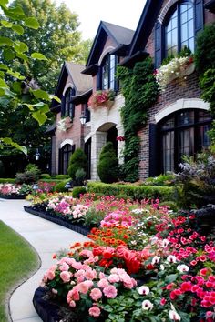 a house with lots of flowers in front of it