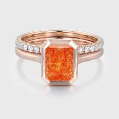 Bask in the warm glow of love with our Sunstone Engagement Ring Set featuring an exquisite Emerald Cut, elegantly crafted in Vintage 14K Rose Gold. Orange Polished Jewelry For Anniversary, Elegant Orange Solitaire Rings, Elegant Orange Emerald Cut Jewelry, Orange Polished Wedding Rings, Orange Polished Wedding Jewelry, Orange Polished Finish Wedding Jewelry, Orange Jewelry With Halo Setting For Anniversary, Orange Halo Setting Jewelry For Anniversary, Elegant Orange Solitaire Jewelry