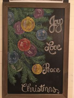 a chalk board with christmas ornaments on it