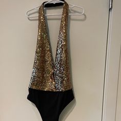 Flattering Low Cut Sequin Body Suit In Gold And Black. Halter With No Back. Never Been Worn! New With Tags Spring Party Backless Bodysuit, Chic Sequined Bodysuit For Night Out, Trendy Backless Party Bodysuit, Trendy Backless Bodysuit For Party, Chic Bodysuit For Date Night And Party Season, Glamorous Stretch Swimwear For Party, Chic V-neck Party Swimwear, Trendy Sleeveless Swimwear For Parties, Chic Bodysuit For Club And Party Season