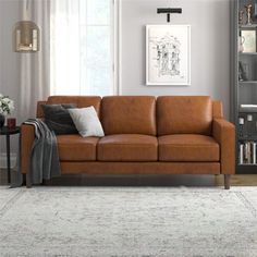 a living room with a couch, coffee table and bookshelf