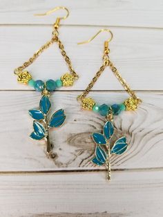 31x18mm enamel metal teal branch. 7x4mm flower spacer beads gold plated. 6&3mm Czech glass faceted rounds in teal. Gold plated chain and fishhook ear wires. Gold Czech Glass Dangle Flower Earrings, Gold Nickel-free Czech Glass Flower Earrings, Nickel-free Gold Czech Glass Flower Earrings, Gold Dangle Flower Earrings With Czech Glass, Nickel-free Gold Flower Earrings With Czech Glass, Nugget Necklace, Reno Nv, Jasper Necklace, Cool Necklaces