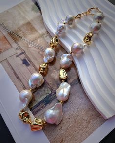 "This flashy necklace features a gold plated rhinestone sun and many natural sparkly Baroque Pearl.The golden stone is tarnish resistant gold plated.Handmade in Vancouver. 🤍Material🤍 40cm length baroque Pearl size:15-18mm Golden stone:16mm-22mm 14K Gold Plated PLEASE NOTE  Due to the natural culturing process each pearl is shaped differently and colors vary,which adds uniqueness to your necklace. Feel free to message me if you have any questions😊 CARE&INFO Give your jewelry a little TLC to keep your jewelry shining bright. Remove body oils, perfumes and lotions with a soft lint-free jewelry cloth that over time will prevent damage to the finish on your beautiful Frons.L jewelry. TOP TIPS Avoid the S's - Sleep, Shower, Swim, Sprays (perfumes) & Sweat (exercise) Fasten up your necklaces a Gold Long Baroque Pearl Necklace, Gold Baroque Pearl Long Necklace, Gold Jewelry With Round Baroque Pearls, Gold Baroque Pearl Beaded Jewelry, Gold Baroque Pearl Bead Jewelry, Gold Pearl Costume Jewelry Necklace, Gold Round Necklace With Jewels, Gold Pearl Necklace With Jewels, Luxury Gold-tone Plated Necklaces