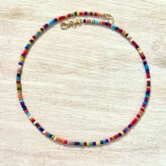 A B O U T - Dainty beaded choker/necklace made with a mix of colorful seed beads. - Carefully crafted to ensure durability so you can wear it everyday. - Perfect for layering with other necklaces or chokers, too! - Every single necklace is different and every bead will differ in size and shape. S I Z I N G - Made to order in your specified size. - Finished with an adjustable 1.5" chain extender. - Sizes 12" & 13" fit very close to the neck, 14" & 156" are a little looser, and sizes 16" & 17" fit Multicolor Letter Beads For Jewelry Making, Colorful Letter Beads For Festival, Colorful Beaded Necklaces With Letter Beads For Jewelry Making, Multicolor Heishi Beaded Necklaces With Large Beads, Beach Choker With Colorful Round Beads, Colorful Heishi Letter Beads, Festival Multicolor Letter Beads, Colorful Beaded Necklaces With Spacer Beads For Festival, Colorful Adjustable Heishi Bead Necklaces