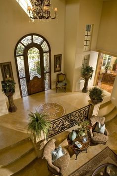 an aerial view of a living room and entryway with stairs leading up to the second floor