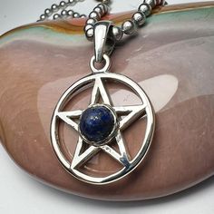 PENTACLE, MAGICKAL,7MM, Lapis  Lazuli 22mm Diameter, Pentagram, Sterling Silver, Magic,  I designed this sterling silver pentacle to last a lifetime. I designed it in the 1980s. I sent the design to my friend Vicki  in Thailand. She made a cast of my design and cast it into silver. this particular pendant was cast in Thailand. I soldered on the bail and set the stone. The size is about 7/8"(22MM) tall, not including the bail. The pendant has a mirror finish on both sides. It is smooth and gentle Mystical Silver Star-shaped Jewelry, Mystical Silver Star Jewelry, Mystical Star-shaped Nickel-free Jewelry, Silver Star Of David Symbolic Jewelry, Nickel-free Mystical Star Jewelry, Sterling Silver Star Of David Jewelry Stamped 925, Spiritual Silver Star Jewelry, Symbolic Silver Star Necklace, Symbolic Sterling Silver Star Jewelry