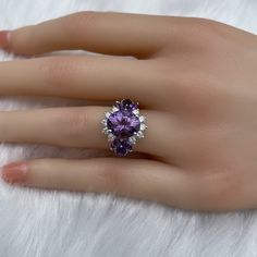 The key stone of this ring is a 11x9mm natural amethysts, and the main material of this ring is sterling silver plated with 18k white gold. On each side of the main stone are one 5x3mm and two 5x2.5mm amethysts. The small accent stones and zircon emphasize the big size of the key stone. Amethyst is a birthstone for February, and the color purple is meant to bring wealth and royalty. Also, many people believe amethyst has the power to relieve stress and purify the mind. Size: Adjustable and fitab Cluster Diamond Gemstones For Wedding, Elegant Multi-stone Open Birthstone Ring, Formal Cubic Zirconia Gemstones, Formal Multi-stone Cubic Zirconia Rings, Exquisite Amethyst Ring With Accent Stones, Classic Crystal Ring With Cubic Zirconia, Elegant Purple Multi-stone Diamond Ring, Fine Jewelry Amethyst Diamond Multi-stone Ring, Luxury Amethyst Ring With Halo Setting For Promise