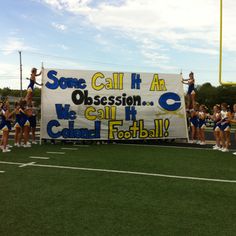 some cheerleaders are standing on the field with a banner that reads, some call it an obsession we call it cold football