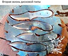 several metal fish on top of a piece of wood with holes in the bottom and sides